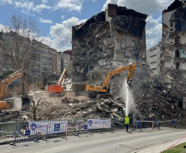 bulldozers near a residential building